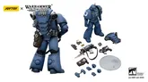 A detailed action figure of a Space Marine in blue armor stands prominently on the left, showcasing its intricate design and authentic markings. Surrounding the figure are various accessories, including a bolt gun, bolt pistol, bayonet, grenades, and interchangeable hands, along with a clear base for display. The figure features 28 points of articulation, allowing for dynamic poses, and is part of a new series from JoyToy.