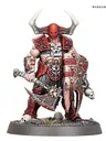 A muscular warrior stands prominently, adorned in red and black armor with sharp spikes and skull motifs. He wields a large, menacing axe in one hand and a shield with jagged edges in the other, both showcasing intricate detailing. His head is covered by a horned helmet, and he stands on a rocky base with sparse grass and skulls scattered around.