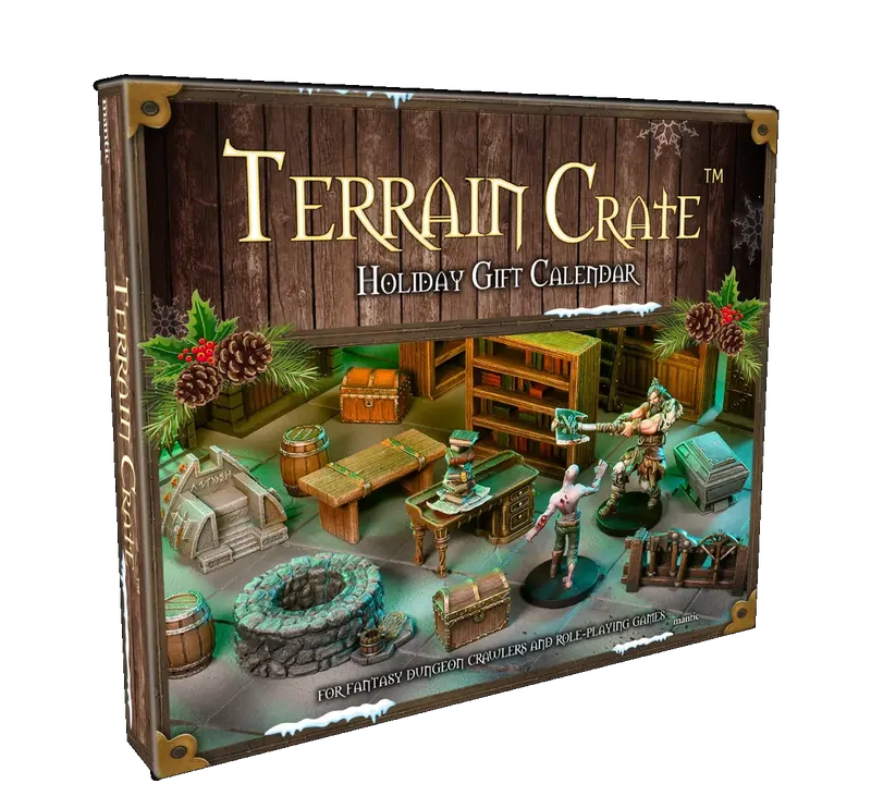 A holiday gift calendar titled "Terrain Crate" is prominently displayed, featuring a wooden background adorned with pinecones and holly. The calendar showcases various miniature terrain pieces, including barrels, crates, a stone well, and a desk, alongside two figures engaged in a fantasy setting. The text on the box indicates it is designed for fantasy dungeon crawlers and role-playing games.