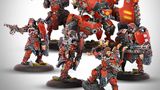 A Khador warband from Warmachine features five miniatures prominently displayed. The unit includes the Warcaster Kapitan Zahara Vilkul, a large character warjack named Razor, and three character solos, including Sergeant Goran Lazarenko and the Hounds. The miniatures are painted in a striking red and black color scheme, showcasing intricate details and weaponry, with Razor towering over the others, emphasizing the unit's vanguard role.