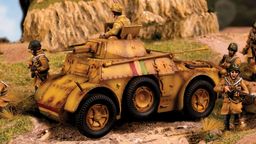 An Italian Autoblinda AB41/43 Armoured Car is prominently featured in the foreground, showcasing a weathered yellow and brown camouflage pattern. The vehicle has a turret with a soldier positioned on top, while several infantry soldiers in tan uniforms are scattered around it, engaged in various poses. The background includes rocky terrain and greenery, enhancing the military setting.