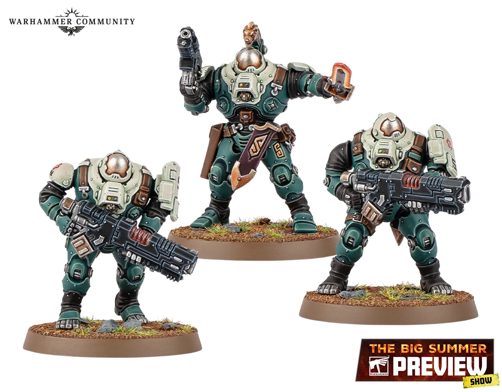 Three miniature figures from the Leagues of Votann are displayed on a grassy base. The central figure, slightly taller, is equipped with a pistol and has a distinctive armor design featuring green and beige colors, along with a decorative belt. The two flanking figures are shorter, one holding a large futuristic weapon, while the other has a more relaxed stance with a hand raised, possibly gesturing. All three figures exhibit a robust, armored appearance typical of the faction's aesthetic.