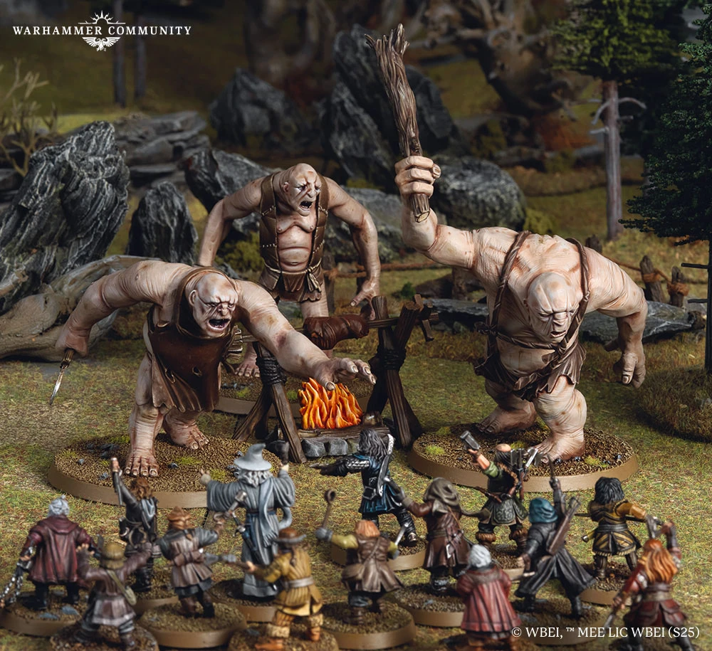 Three large trolls, each with distinct features and wielding makeshift weapons, are positioned around a campfire in a forested setting. In the foreground, a group of characters from Thorin's Company, including dwarves and a wizard, are depicted in various poses, preparing for confrontation. The scene captures the tension of the moment, with detailed terrain elements like rocks and trees enhancing the atmosphere.
