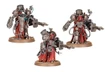 Three Myrmidon Destructor miniatures stand prominently, showcasing their imposing designs. Each figure features a combination of metallic armor and flowing red robes, with intricate mechanical details and various weaponry, including large energy cannons. The miniatures are posed dynamically, emphasizing their role as formidable combatants within the Mechanicum's martial forces.