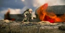 A detailed miniature of a U.S. soldier, Hershel W. 'Woody' Williams, is depicted in action, equipped with a flamethrower on his back and wearing a helmet and military uniform. He is positioned on a textured base that resembles a battlefield, with a backdrop of flames and smoke suggesting a combat environment. The scene captures the intensity of the Pacific theatre during World War II.