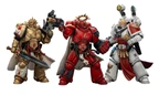 Three action figures representing Blood Angels Space Marines stand side by side. The first figure on the left is clad in red armor, holding a gun, and features intricate detailing. The central figure, also in red, has a prominent golden halo and a cape, while the figure on the right wears white armor with red accents and is equipped with various accessories, including a holstered weapon and a mechanical arm.