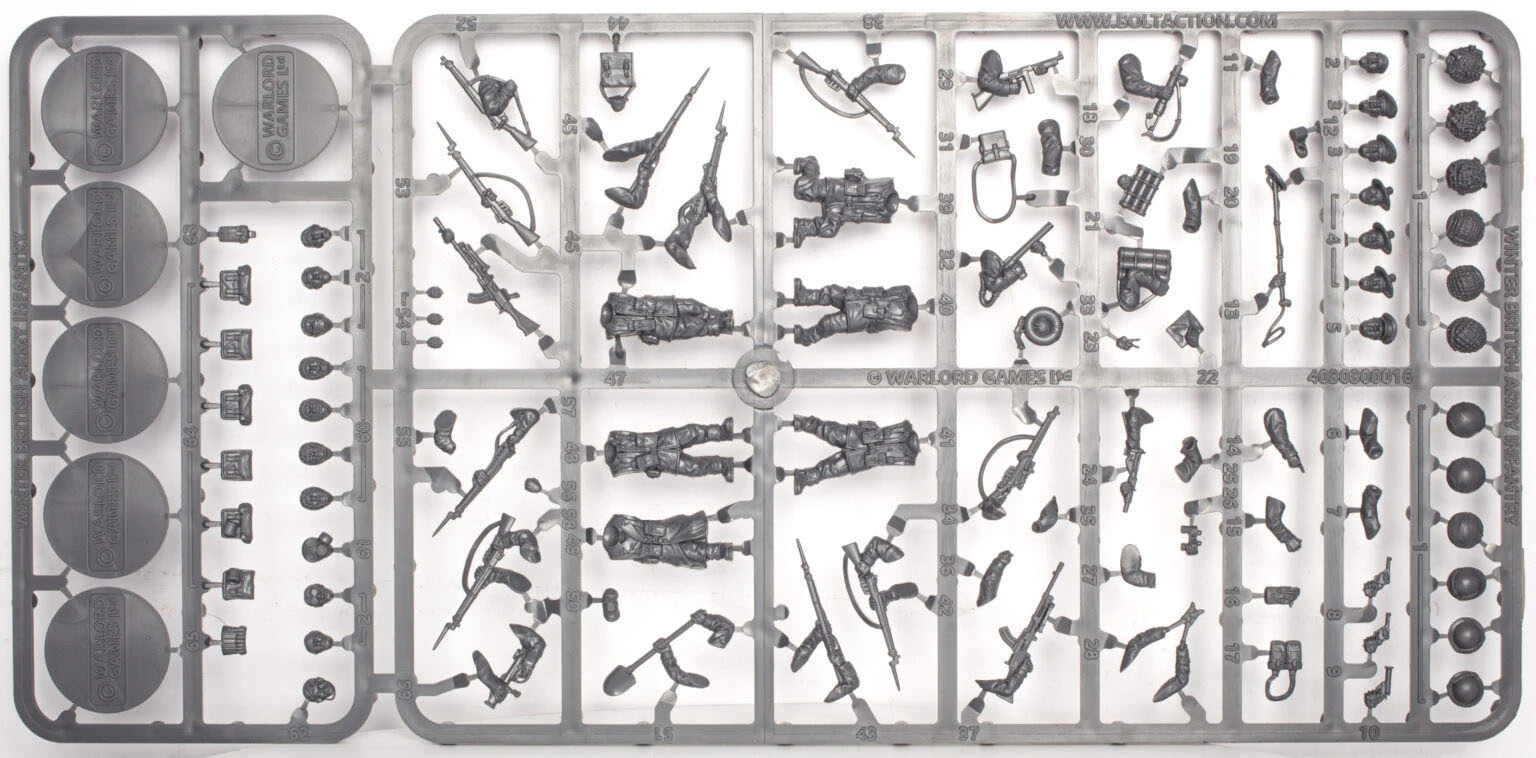A sprue featuring multi-part figures of British and Canadian winter infantry, showcasing six distinct soldier poses, all equipped with various winter gear. The sprue includes an assortment of weapons such as rifles, machine guns, SMGs, and specialist items like sniper rifles, mortars, and flamethrowers, along with engineering tools like shovels and mine sweepers. The figures are intricately detailed, emphasizing their readiness for winter conditions.