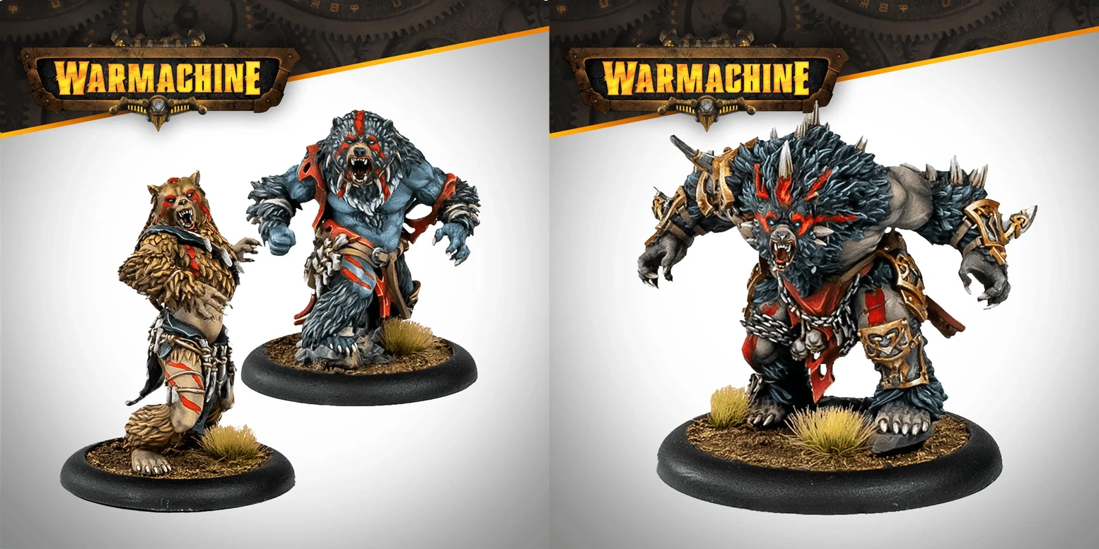 Two detailed miniatures from the Khador Old Umbrey Auxiliary Expansion for Warmachine are showcased. On the left, a large, muscular figure with blue skin and a fierce bear-like appearance, adorned with red markings and tribal accessories, stands ready for battle. On the right, another imposing figure, similarly styled with a rugged look and equipped with armor and weapons, exudes a menacing presence. Both figures are mounted on circular bases with tufts of grass, emphasizing their wild and savage nature.