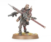 A detailed miniature figure of a Goremonger stands on a textured base adorned with tufts of grass. The figure features a muscular build, wearing a mix of armor and leather, with a menacing mask and spikes on the head. In one hand, it wields a large, jagged weapon, while a firearm is slung across its body, showcasing a gritty, post-apocalyptic aesthetic.