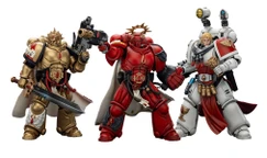 Three action figures representing Blood Angels Space Marines stand side by side. The first figure on the left is clad in red armor, holding a gun, and features intricate detailing. The central figure, also in red, has a prominent golden halo and a cape, while the figure on the right wears white armor with red accents and is equipped with various accessories, including a holstered weapon and a mechanical arm.