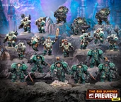 A group of miniature figures representing the Leagues of Votann stands prominently against a rocky, textured backdrop. The models are predominantly clad in teal and dark armor, showcasing various weapons and equipment, including guns and melee weapons. The scene features a mix of characters, including a central figure with a glowing sword, all arranged in a dynamic formation that highlights their unique designs and details.