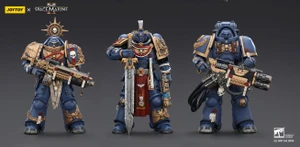 Three detailed action figures from the Warhammer 40,000: Space Marine series are displayed against a dark background. On the left, the Relic Primus Armor figure holds a heavy bolt rifle, adorned with intricate decorations, including a skull emblem and a shield. To the right, the Heavy Artificer Armor figure wields a large combat blade, featuring a flowing red cape and various honor ribbons, showcasing the iconic blue and gold color scheme of the Ultramarines chapter.