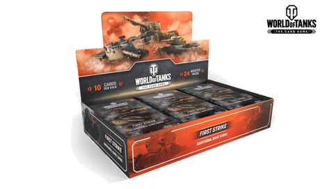 A display box for the "World of Tanks: The Card Game" features 24 booster packs, prominently labeled "FIRST STRIKE" for additional game cards. The box has a striking design with a dark background and vibrant orange accents, showcasing images of tanks and battle scenes. The "WORLD of TANKS" logo is displayed at the top, emphasizing the game's connection to the popular video game.