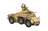 A detailed model of a military vehicle, featuring a tan and brown camouflage pattern with weathering effects. The vehicle has large, rugged wheels and is equipped with two visible cannons on the turret. A figure of a soldier in a uniform and cap is positioned on top, waving, adding a dynamic element to the scene.