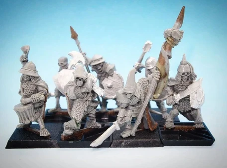 A collection of 28mm scale skeleton warriors from Diehard Miniatures, featuring several figures in various poses. The miniatures are equipped with weapons such as spears and swords, and are adorned with armor and helmets reminiscent of classic Oldhammer designs. The background is a soft blue gradient, highlighting the details of the skeletal figures, which are mounted on black bases.