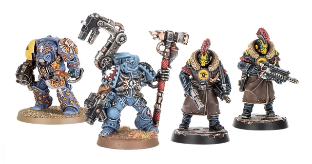 Three miniatures from the Palanite Enforcer Captains & Sergeants set are displayed. On the left, a figure wields a large axe and wears a blue and brown uniform with a fur collar, while the two figures on the right are equipped with firearms and feature distinctive yellow masks and red mohawks. All three are mounted on circular bases, showcasing intricate details in their armor and accessories.