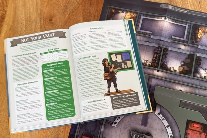 An open tabletop gaming book titled "NOT YOUR VAULT" displays sections on starting the adventure, key locations, and secrets and clues, with a character illustration beside a bulletin board. The book is placed on a wooden surface, and a game map featuring a detailed layout of rooms and corridors is visible in the background. The map includes various elements like walls, doors, and lighting, enhancing the gaming environment.