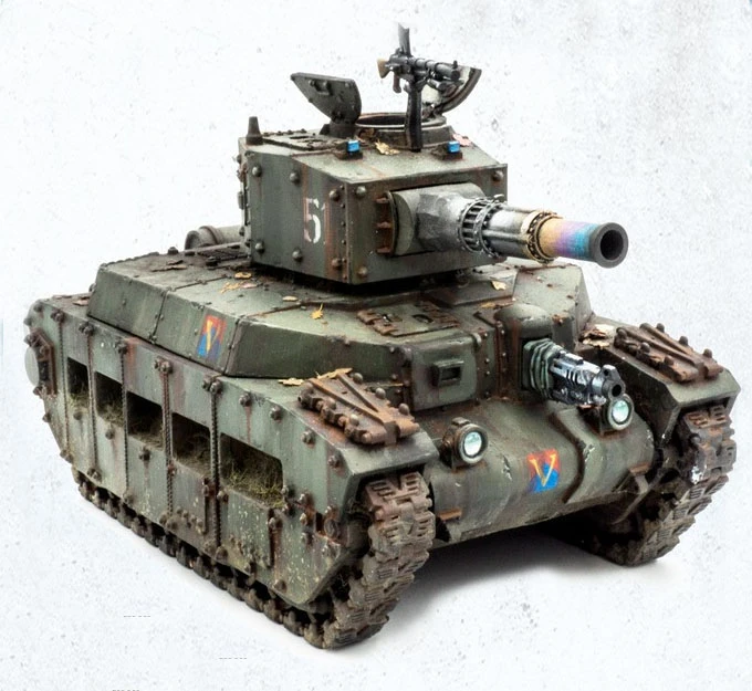A detailed model of a mechanized tank, featuring a rugged green exterior with weathering effects and patches of foliage. The tank has a prominent turret with a large cannon, adorned with a colorful muzzle, and a smaller machine gun mounted on top. Various markings, including a number