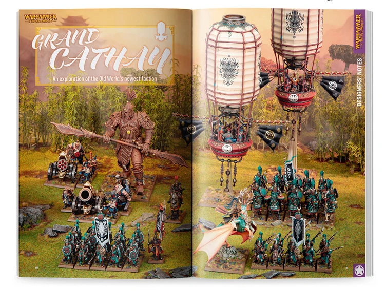 A vibrant spread showcases the new Grand Cathay faction, featuring a variety of intricately detailed miniatures. Prominent in the scene is a large armored figure wielding a weapon, alongside several smaller units adorned in teal and gold, with one character flying on a dragon-like creature. Above, two ornate hot air balloons with decorative patterns float, adding a fantastical element to the lush, green backdrop.