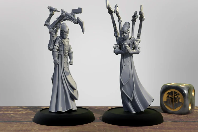 Two detailed 3D printed miniatures stand on black bases, showcasing the Cephalyx Mind Slayers from the Warmachine universe. Each figure is dressed in long, flowing robes and features a distinctive mask, with one holding a pair of mechanical arms equipped with weapons, while the other has its hands clasped in a gesture of focus. The background is a simple gradient, emphasizing the intricate designs of the miniatures, with a decorative die featuring a symbol from the game placed nearby.