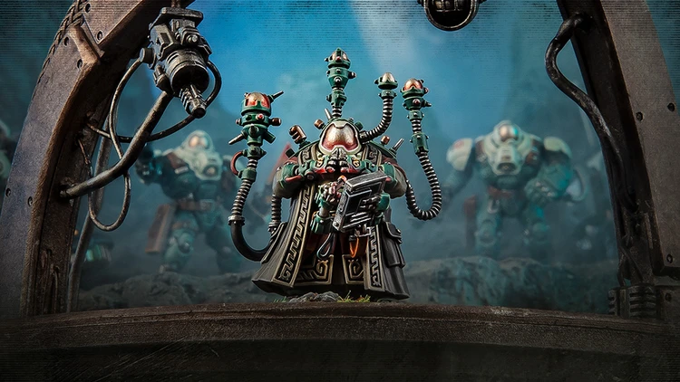 A detailed miniature figure stands prominently in the foreground, featuring a character with a complex helmet and multiple mechanical appendages extending from its back, each topped with small, glowing orbs. The figure is dressed in a dark, ornate robe, holding a device in one hand, while two other armored figures are partially visible in the background, suggesting a sci-fi setting. The scene is set against a moody, atmospheric backdrop that enhances the futuristic theme.