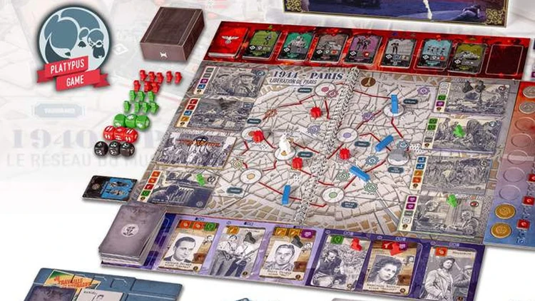 A tabletop game setup features a detailed game board depicting Paris, with various pathways and locations marked. Red and green player pieces are scattered across the board, alongside dice in red and black. Several decks of cards are arranged at the bottom, showcasing character artwork, while a box labeled
