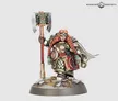 Miniature figure of a Khazalite duardin warrior in detailed armor, holding a large axe with a red-wrapped handle. Armor features red, green, and metallic accents. Standing on a rocky base with sparse vegetation.