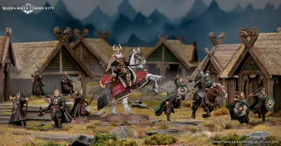 A detailed scene features Helm Hammerhand, King of Rohan, depicted both mounted on an armoured horse and on foot, alongside several Rohirrim warriors. The figures are intricately painted, showcasing vibrant colors and detailed armor, set against a backdrop of rustic wooden structures resembling Rohan architecture. The environment includes rocky terrain and hints of mountainous scenery, enhancing the thematic setting of the Middle-earth Strategy Battle Game.