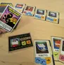 Cards and game pieces from the Homestar Runner game Crime Scene Tamperer on a wooden table.