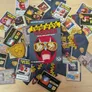 Crime Scene Tamperer game box surrounded by cards and tokens on a wooden table.
