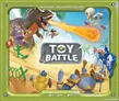 A colorful and dynamic game cover for "Toy Battle" features a playful scene set on a sandy beach. Prominent characters include a roaring dinosaur shooting a fiery projectile, a pirate monkey, and various whimsical toys like a unicorn and knights in armor. The title "TOY BATTLE" is displayed prominently in the center, framed by a vibrant green border.