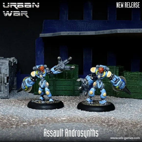 Two Assault Androsynth miniatures are prominently displayed in the foreground, designed for hand-to-hand combat. They feature a blue and yellow color scheme, with one holding a Vibro Scythe and the other a Cesti, showcasing their imposing, armored forms. The background includes dark crates and a textured surface, enhancing the urban warfare theme.