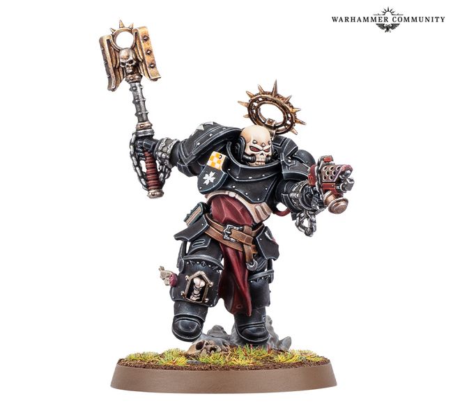 A Black Templars Execrator stands in a dynamic pose, wielding a large, ornate power hammer in one hand and a pyre pistol in the other. The figure is clad in black armor adorned with gold and silver details, including a skull motif on the helmet and a purity seal on the chest. The base features a grassy terrain with scattered skulls, enhancing the grim aesthetic typical of the Warhammer 40,000 universe.