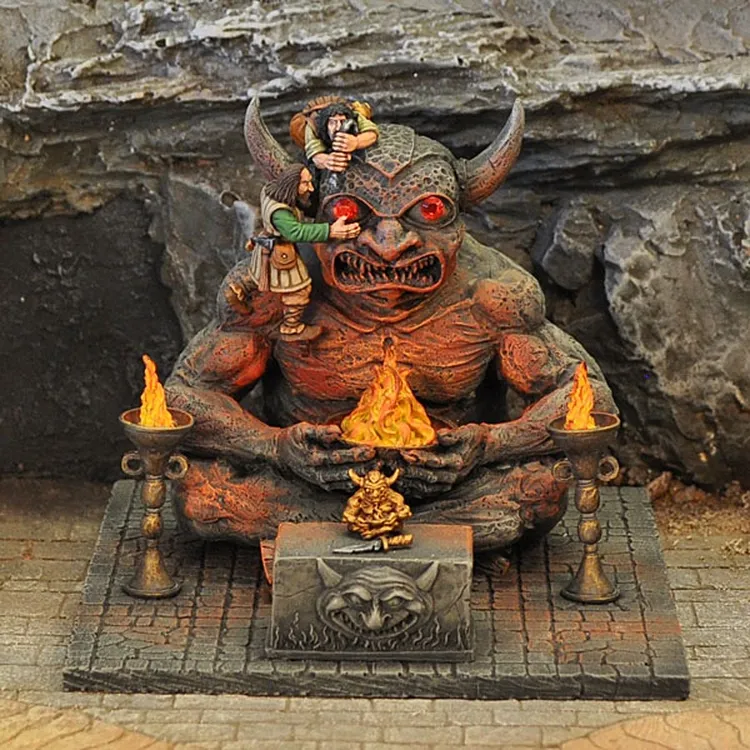 A large, menacing demon figure sits cross-legged, with prominent horns and glowing red eyes, surrounded by flames emanating from two braziers on either side. On its lap, a smaller figure appears to be offering a tribute, while another figure climbs onto the demon's shoulder, creating a dynamic scene. The base features intricate stonework, enhancing the overall fantasy aesthetic.