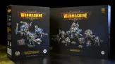The image features two box sets from Steamforged Games for the Cygnar faction in the Warmachine tabletop game. On the left, the "Cygnar Gravediggers Battlegroup Box Set" showcases a warcaster and two warjacks, with vibrant blue and metallic details on the miniatures. On the right, the "Cygnar Gravediggers Command Starter" includes a more diverse array of models, featuring a heavy warjack, a three-model unit, and a character solo, all set against a dark background that highlights the colorful packaging and intricate designs.