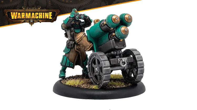 A Crucible Guard Mechanik stands beside a large, wheeled artillery piece, showcasing a blend of teal and brown armor with intricate detailing. The Mechanik is equipped with goggles and a tool belt, emphasizing their role in maintaining war machines. The base features tufts of grass, adding a touch of realism to the miniature's presentation.