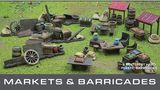 A detailed tabletop scene features a variety of marketplace elements, including wooden stalls, barrels, crates, and bags, all set on a grassy surface. The scene showcases multiple tables with assorted food items and decorative pieces, emphasizing the bustling atmosphere of a market. Above the scene, the text "GENERAL ACCOUTREMENTS" and "MARKETS & BARRICADES" is prominently displayed, indicating the theme of the set.