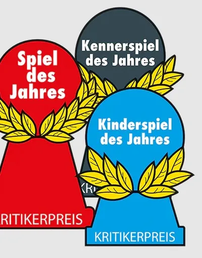 Three award trophies are displayed, each representing a different category of the Spiel des Jahres. The red trophy, labeled "Spiel des Jahres," features a laurel wreath design, symbolizing the Game of the Year. The gray trophy, labeled "Kennerspiel des Jahres," represents the Connoisseur Game of the Year, while the blue trophy, labeled "Kinderspiel des Jahres," signifies the Children's Game of the Year. All trophies are marked with the text "KRITIKERPREIS" at the base.
