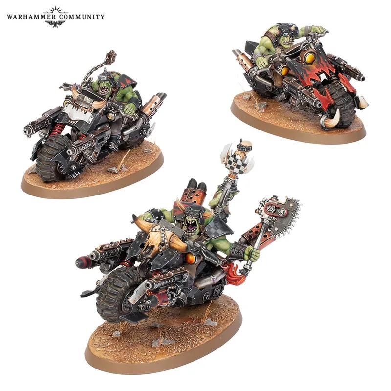 Three green Ork figures riding motorcycles on circular bases.