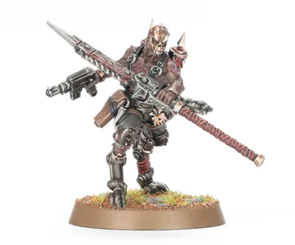 A detailed miniature figure of a Goremonger stands on a textured base adorned with tufts of grass. The figure features a muscular build, wearing a mix of armor and leather, with a menacing mask and spikes on the head. In one hand, it wields a large, jagged weapon, while a firearm is slung across its body, showcasing a gritty, post-apocalyptic aesthetic.