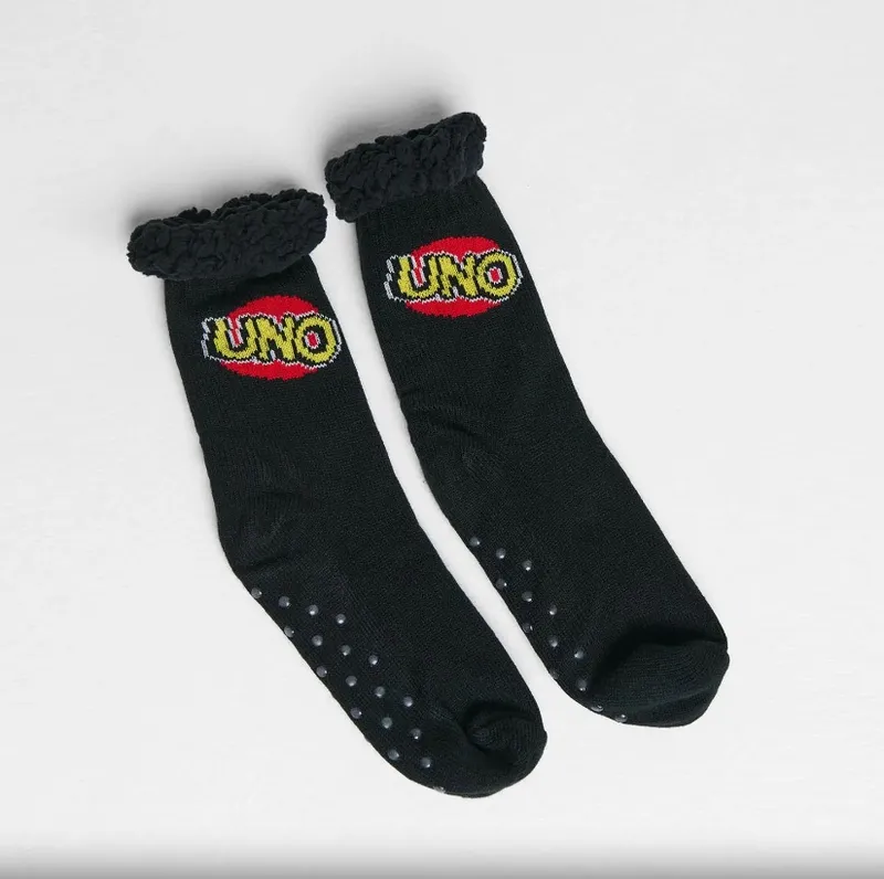 Black socks with "UNO" logo, ruffled tops, and grips on soles.