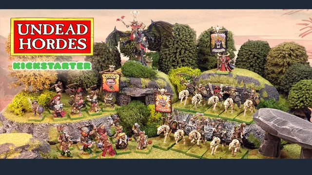 The scene features a vibrant tabletop display showcasing the "Undead Hordes" miniatures from Red Bard Games' Kickstarter campaign. In the foreground, a variety of skeletons and zombies are arranged on grassy terrain, with some holding banners and others in dynamic poses. A prominent liche king rides a zombie dragon atop a rocky outcrop, while additional figures, including a necromancer and various undead warriors, populate the scene, surrounded by lush greenery and stone formations. The overall composition exudes a classic fantasy aesthetic, emphasizing the theme of an undead army ready for battle.