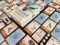 A box labeled "Wingspan Pocket" with illustrations of birds and a nest on a branch. Surrounding the box are game cards featuring bird illustrations, eggs, and buttons. Some cards have visible text such as "AT LEAST 1 CARD TUCKED BEHIND IT", "STARTING HERE, ACTIVATE", and "PLAY A BIRD".