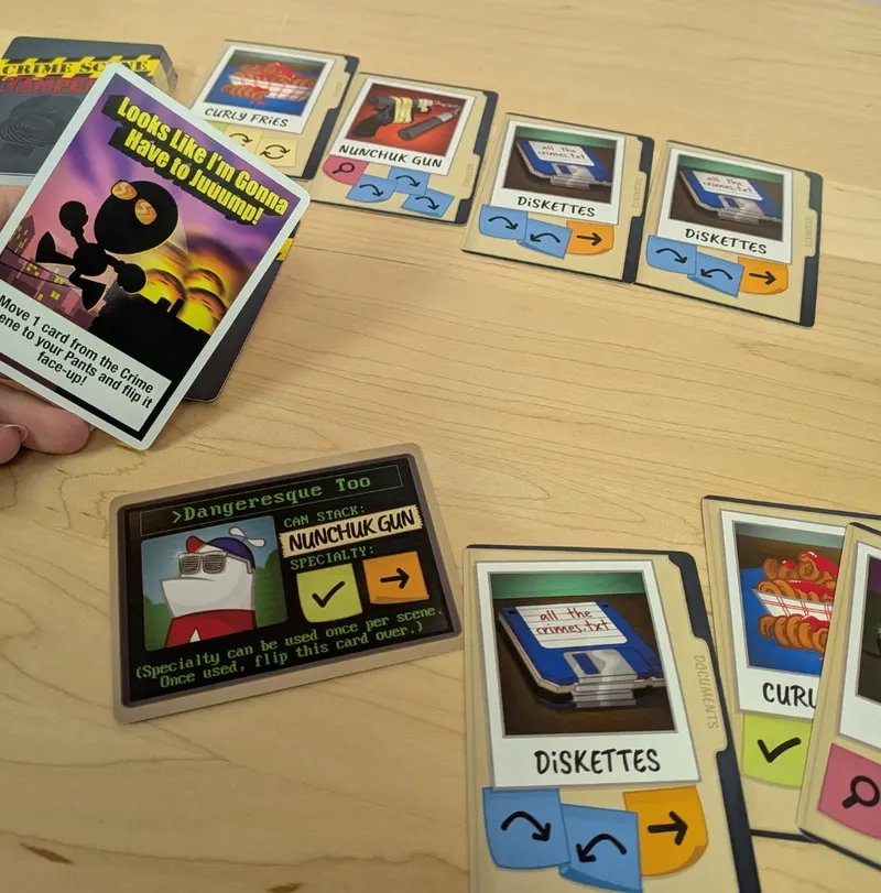 Cards and game pieces from the Homestar Runner game Crime Scene Tamperer on a wooden table.