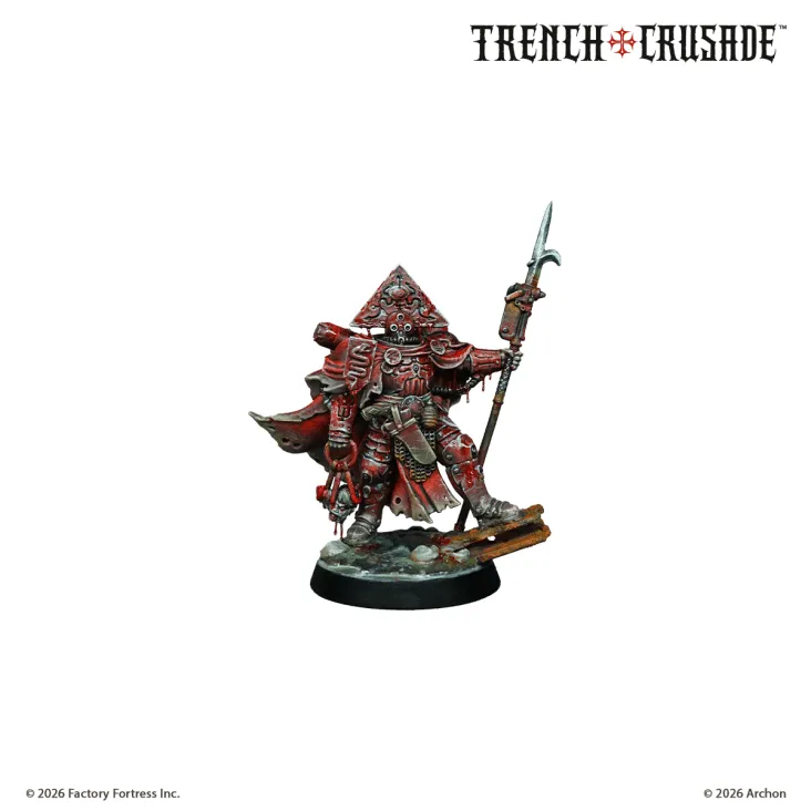 A detailed miniature figure stands prominently, dressed in a striking red robe adorned with intricate patterns and symbols. The figure wears a distinctive triangular headpiece and holds a spear in one hand, while the other hand is positioned as if ready to wield a weapon. The base features a rocky terrain, suggesting a battlefield setting, and the overall design reflects the grimdark aesthetic of the Trench Crusade game.