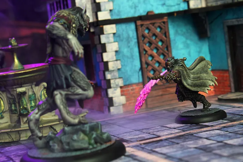 Miniature figure with pink energy blade in a fantasy street setting.