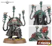 A detailed miniature of a character from the Leagues of Votann, featuring a robust figure clad in a long, dark robe with intricate patterns. The character has a prominent, rounded chest piece and is equipped with various high-tech devices, including multiple antennae and a weapon in one hand. The base is adorned with small rocks and grass, enhancing the sci-fi aesthetic of the model.