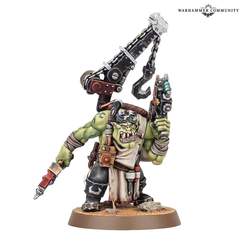 Green-skinned Ork miniature with cybernetic arm and large gun, on a round base.