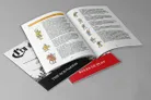 An open booklet displays pages featuring colorful illustrations of medieval characters, including peasants and knights, alongside text detailing scenarios and rules of play. The cover of the booklet is partially visible, showcasing the title "Cry Havoc" in a stylized font, with a black and white illustration of a sword. The layout includes sections labeled "THE SCENARIOS" and "RULES OF PLAY," with a vibrant red background for the latter.