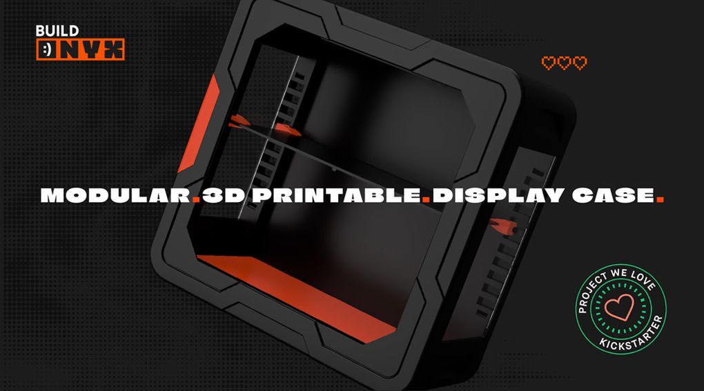 A sleek, 3D-printable display case designed for collectors, featuring a black exterior with angular lines and a vibrant red base. The case is shown from a slightly elevated angle, highlighting its modular design and snap-fit assembly, which requires no tools. The text "3D-PRINTABLE. DISPLAY CASE." is prominently displayed, along with a "PROJECT WE LOVE" badge from Kickstarter.
